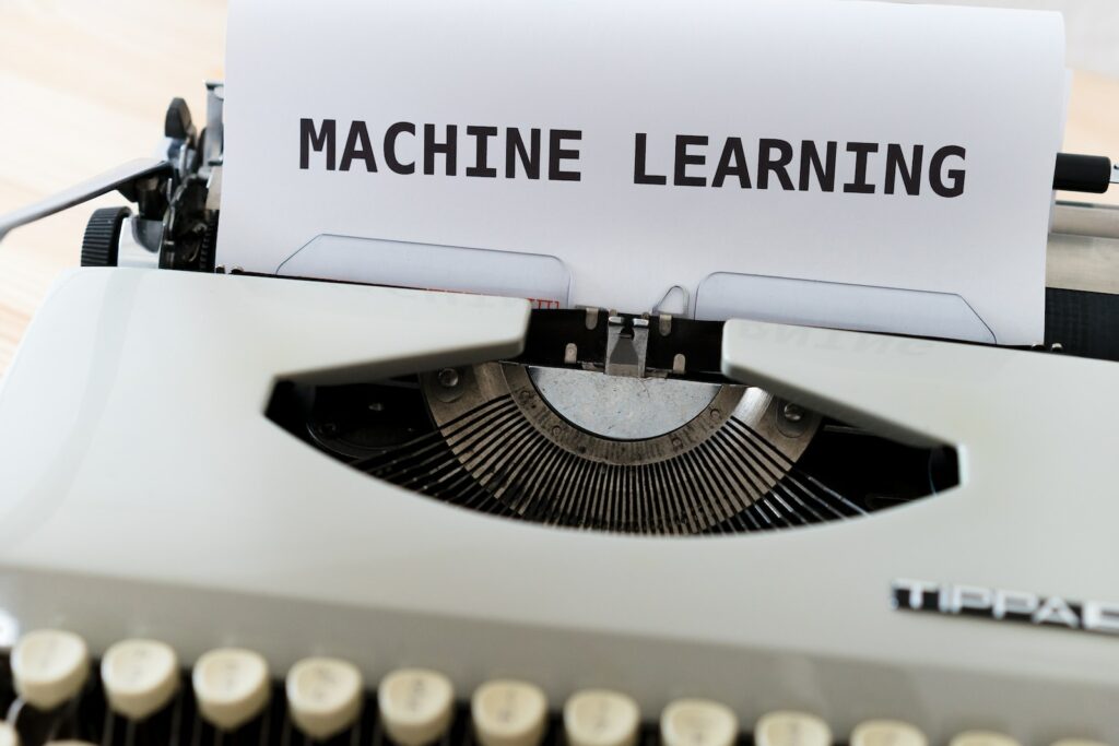 a close up of a typewriter with a paper reading machine learning