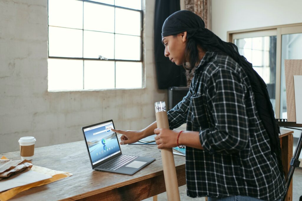 a person sitting at a table with a laptop